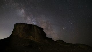 A starry sky is the backdrop for finding alien planets.