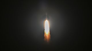 Vulcan rocket launch showing rocket against a black sky with billowing flames from the engines below