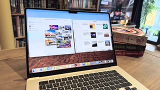 The 2024 MacBook Air M3 on a wooden table in front of a bookshelf.