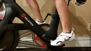 A photo of the Nike SuperRep cycling shoes on a Peloton bike