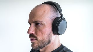 Wearing the Sennheiser Momentum 4 Wireless.