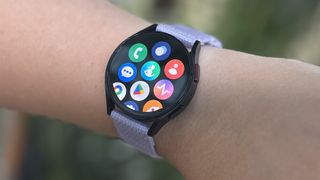 Samsung Galaxy Watch 6 on a user's wrist with a purple cloth strap