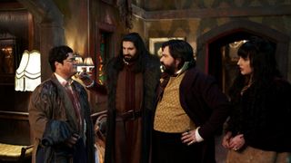 (L to R) Guillermo (Harvey Guillén), Nandor (Kayvan Novak), Laszlo (Matt Berry) and Nadja (Natasia Demetriou), the roommates of What We Do in the Shadows, inside their dark and murky home