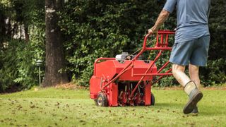 A gas powered aerator being used on a lawn