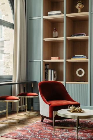 Ameron lounge with herringbone marble flooring and red patterned carpet