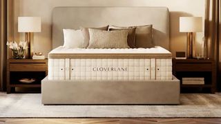 Cloverlane Hybrid Mattress placed on a beige fabric bedframe in a stylish bedroom