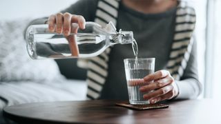 Image of person piuring water to drink