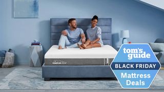 A couple sits on the Tempur-Pedic Tempur-Cloud Mattress on a bed frame in a bedroom, a Tom's Guide Black Friday mattress deals graphic (right)