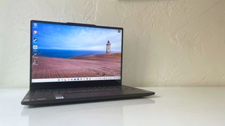 The Lenovo IdeaPad 5 2-in-1 with lid open on a white table