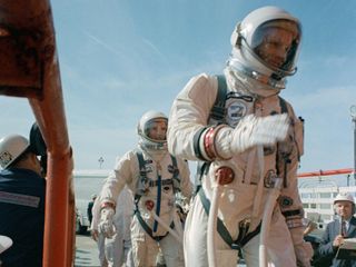 Commander Neil Armstrong (right) and pilot David R. Scott prepare to board the Gemini-Titan 8.