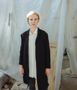 woman with blonde hair, wearing white shirt and black kacket