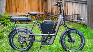 An electric bike in a backyard surrounded by grass