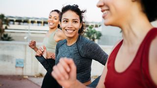 a photo of a woman running with friends