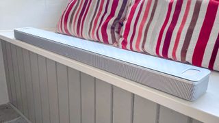 Bose Smart Ultra Soundbar in white placed on a window seat