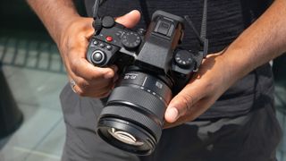 Panasonic Lumix S5 IIX being held by DCW reviewer Jon Devo