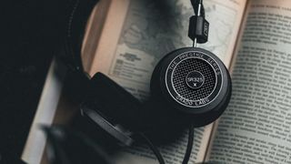 Grado SR325x headphones hung over an open book