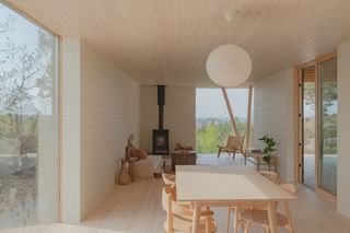 The cabin interior with a log burning fire place