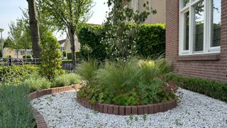 Brick borders around plants in yard