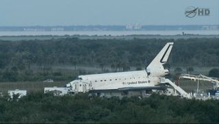 Space shuttle Atlantis is seen on the runway after making a predawn landing at NASA's Kennedy Space Center on July 21, 2011 to end the agency's 30-year shuttle program. It was the 135th and final shuttle flight.