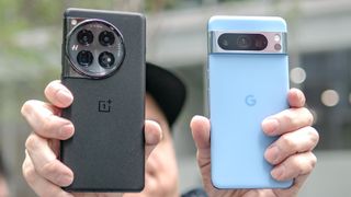 Pixel 8 Pro vs OnePlus 12 held in both hands.