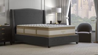 Image shows the Saatva RX mattress, on sale for up to $400 off most months, placed on a grey fabric bedframe