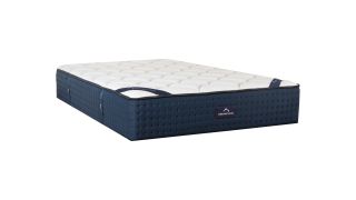 DreamCloud vs Saatva: The DreamCloud Luxury Hybrid shown with a navy base and white top