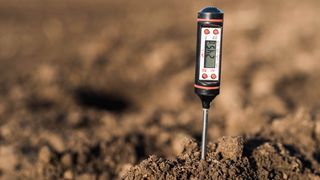 A soil test in the soil taking a pH reading