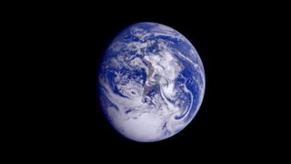 This color image of the Earth was taken by the European Space Agency's Galileo spacecraft on Dec. 11, 1990, as it departed on its three year flight to Jupiter. Antarctica is visible at the bottom of the image, and dawn is rising over the Pacific Ocean.