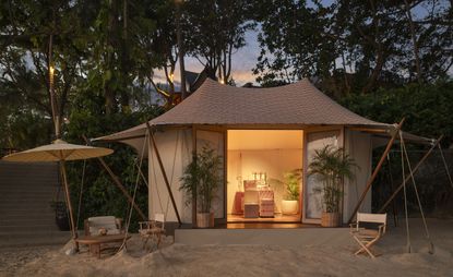 Aman cabana pop-up shop in a beach setting with a Thai-inspired roof