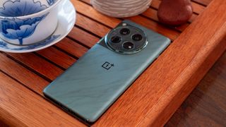 The OnePlus 12's green marble-like back