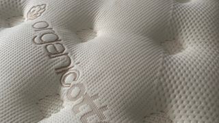 Close up of pillow top cover on Saatva Classic mattress for side sleepers