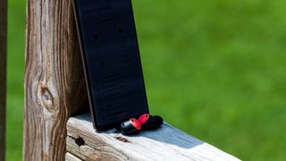 Google Pixel Buds Pro in front of Pixel 6 Pro on ledge