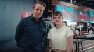 A screenshot of Seth Meyers and Kristen Stewart standing side by side and talking to the camera in Day Drinking.