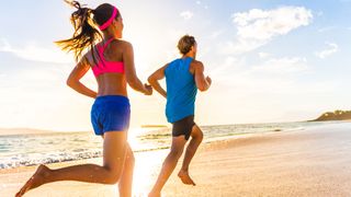 Couple running on a sandy beach