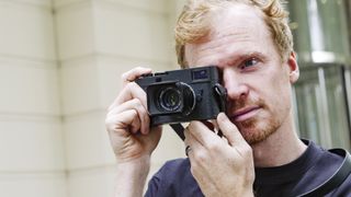 Leica M11-D camera held up to photographer's eye