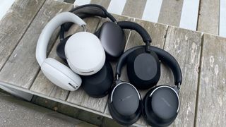 Sonos Ace, Sony WH-1000XM5, Apple AirPods Max and Bose QC Ultra Headphones together on a bench