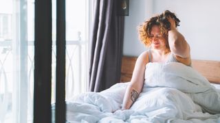 A woman waking up groggy in the morning experiencing sleep inertia