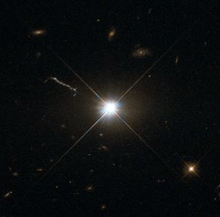 The Hubble Space Telescope captured this image of ancient and brilliant quasar 3C 273, which resides in a giant elliptical galaxy in the constellation of Virgo. Its light has taken some 2.5 billion years to reach us. Despite this great distance, it is still one of the closest quasars to our home. It was the first quasar ever to be identified, and was discovered in the early 1960s by astronomer Allan Sandage.