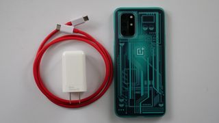 OnePlus WarpCharger 65W next to OnePlus 8T