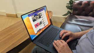 15-inch MacBook Air on wooden table at home