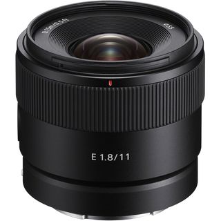 Sony E 11mm f/1.8 lens on a white background