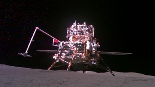 a silvery-white spacecraft on the surface of the moon.