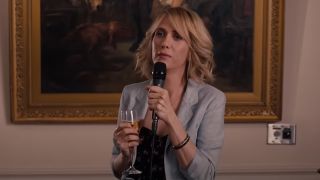 Kristen Wiig holding a mic in Bridesmaids.