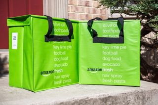 Amazon Fresh bags standing on a doorstep