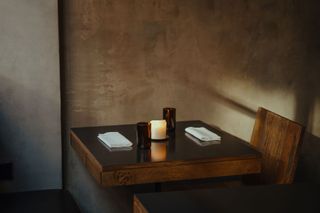 Wooden table and chair inside Paradise 2.0 restaurant, London