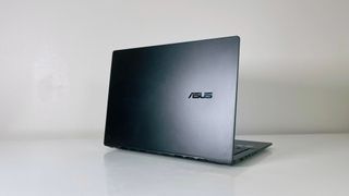 The Asus Vivobook S14 on a white table seen from behind