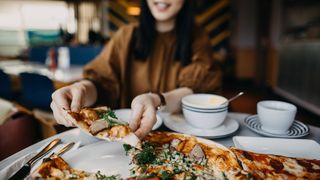 Woman eating pizza