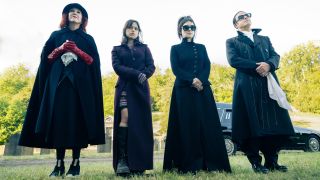 Catherine O'Hara, Jenna Ortega, Winona Ryder, and Justin Theroux stand outside, dressed for a funeral, in Beetlejuice Beetlejuice.