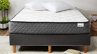 The Amazon Basics Hybrid Mattress in a bright bedrrom