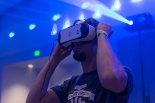 Guy tries virtual glasses headset during VRLA Expo, virtual reality exposition, event at the Los Angeles Convention Center in Los Angeles in August 2015.